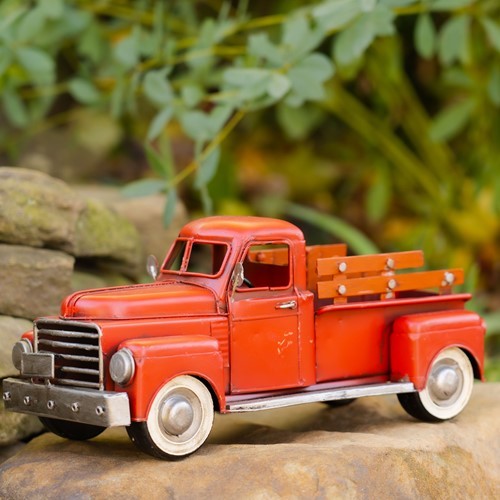 Vintage Style Iron Pickup Truck in Red with White Rims and Fence